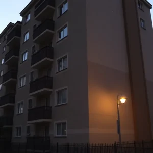 Quiet apartment complex at dusk, reflecting somber atmosphere.