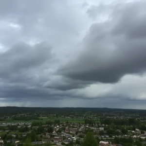 Dark clouds looming over a small town landscape.